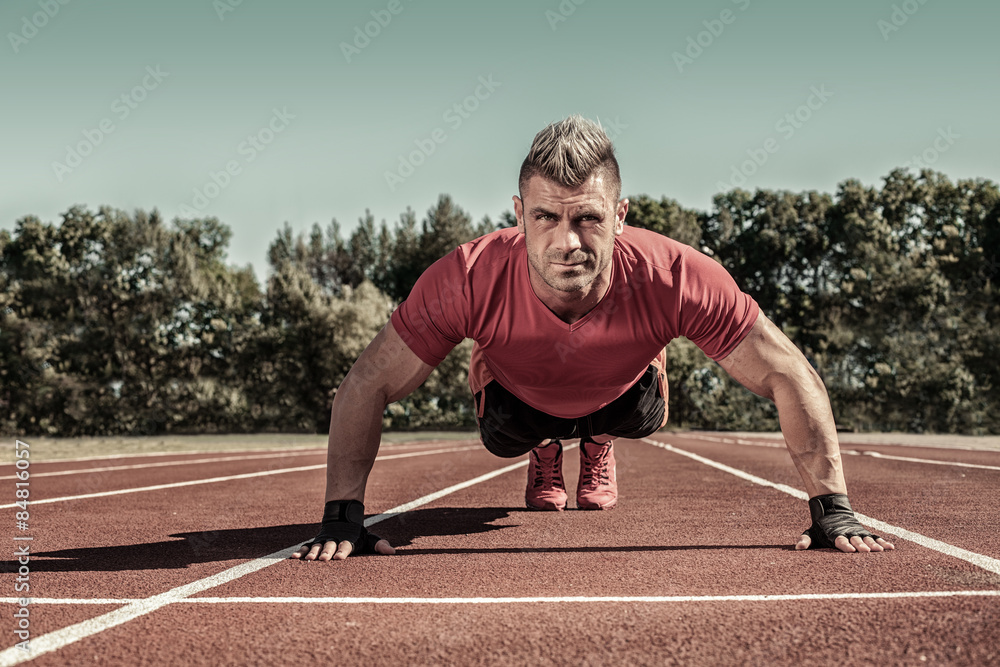 Handsome young shirtless Caucasian fitness man doing push-ups ou Handsome young shirtless Caucasian fitness man doing push-ups ou