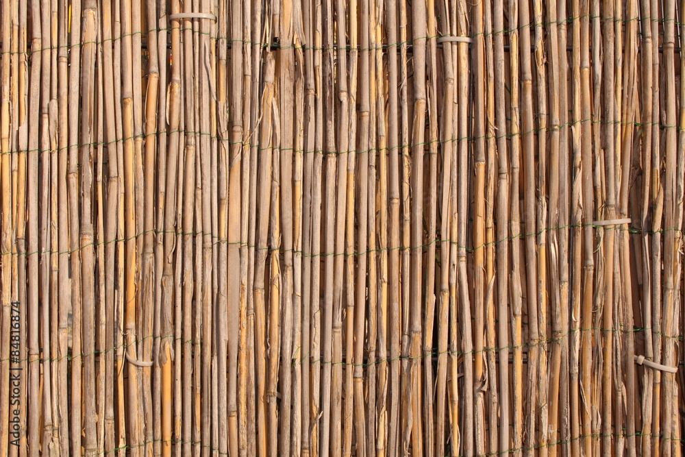A wooden background with vertical reeds