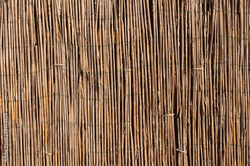A wooden background with vertical reeds