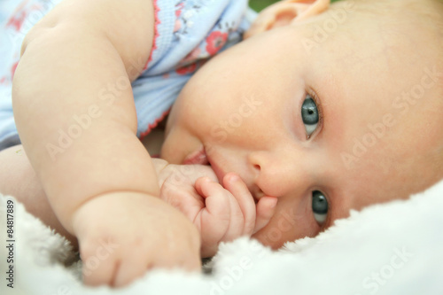 Newborn Baby Girl Laying Down Sucking Her Thumb