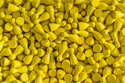 Unicolored background pattern made from yellow gamefigurines
