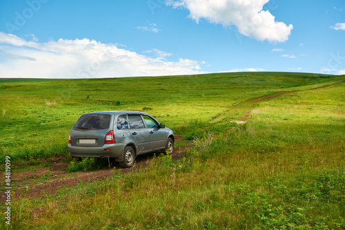 Cars driving on a dirt road to the top of the hill