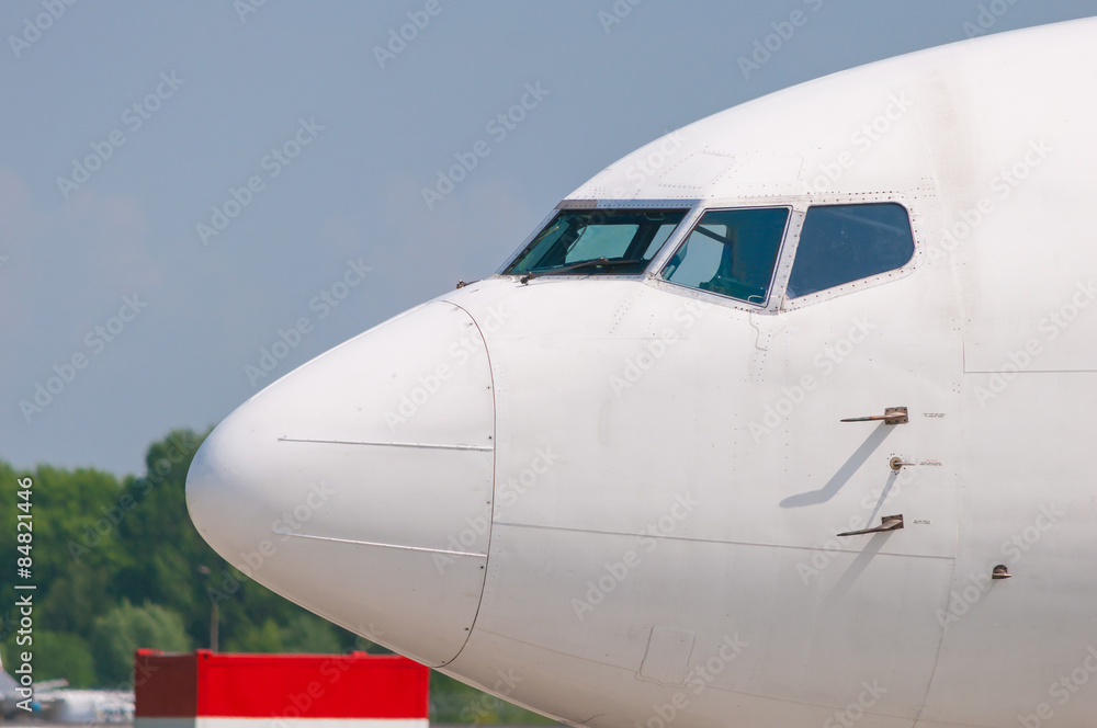 White passenger airline cocpit with windows, view from outside. Transportation background White passenger airline cocpit with windows, view from outside. Transportation background