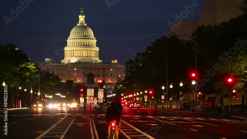 United States Capitol building night view from Pennsylvania Avenue with car lights photo