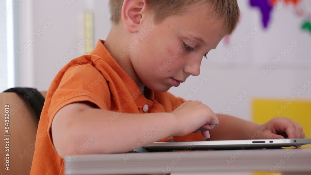 Child at school using digital tablet, closeup Child at school using digital tablet, closeup