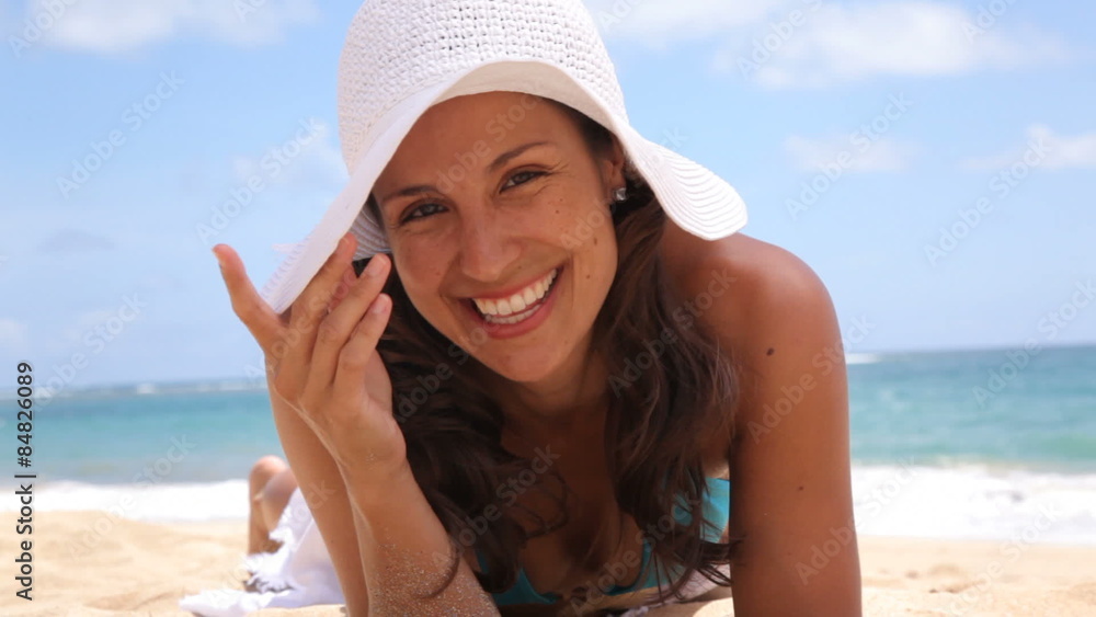 Portrait of young woman laying on sandy beach Portrait of young woman laying on sandy beach