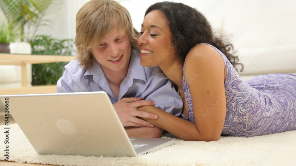 Couple looking at laptop computer together Couple looking at laptop computer together