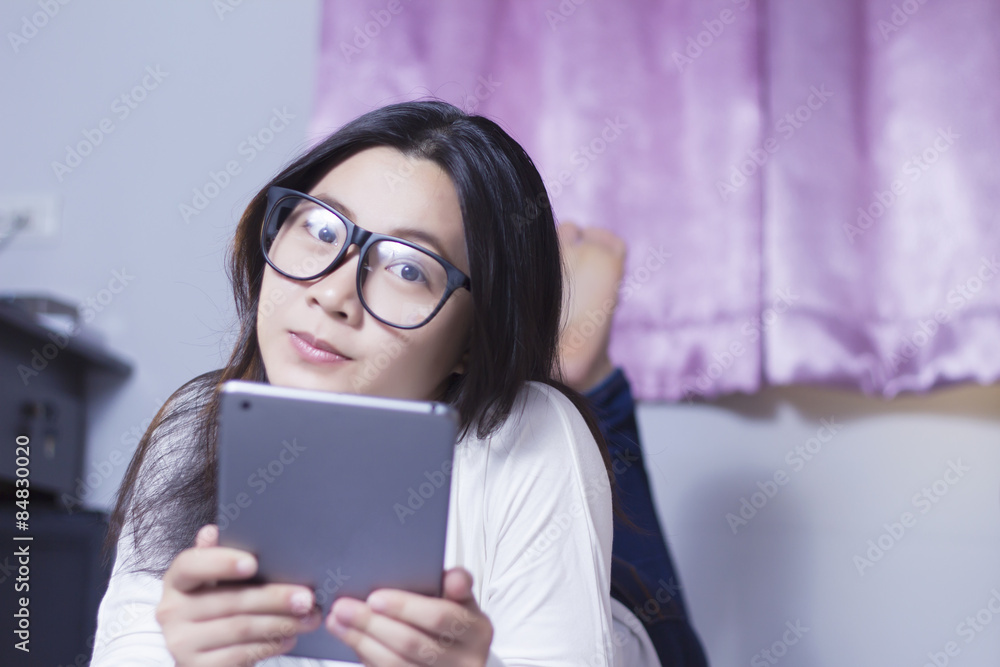 Woman using a tablet at bedroom Woman using a tablet at bedroom