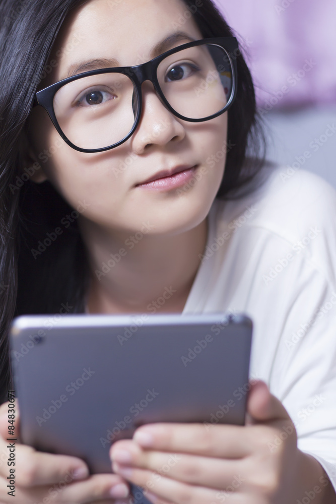 Woman using a tablet at bedroom Woman using a tablet at bedroom