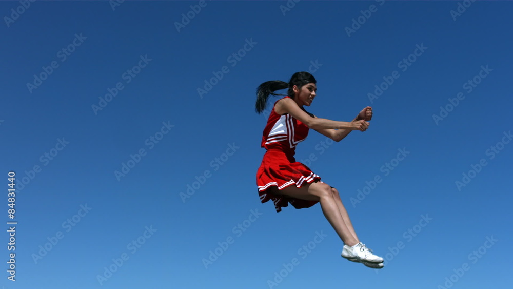 Cheerleader performs aerial stunt , slow motion Cheerleader performs aerial stunt , slow motion
