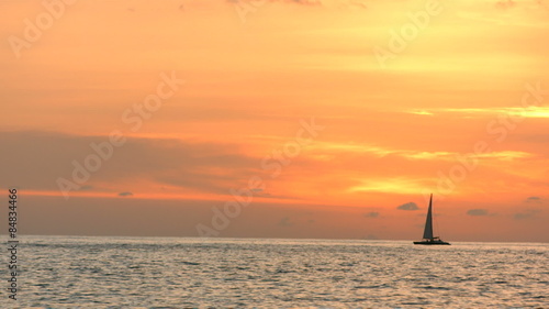 Sailboat on the ocean at sunset