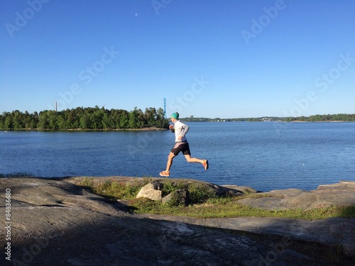 Runner on rocks besides inlet photo