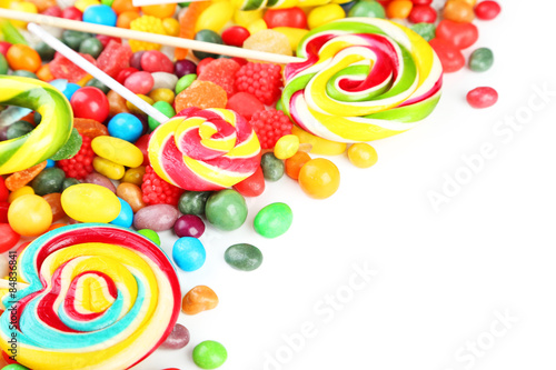 Different fruit candies on white background