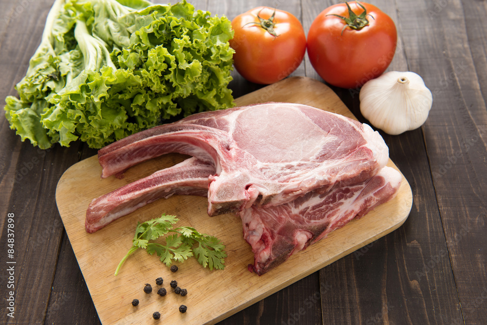 Fresh Raw Pork Chops and vegetable on wooden background. Fresh Raw Pork Chops and vegetable on wooden background.