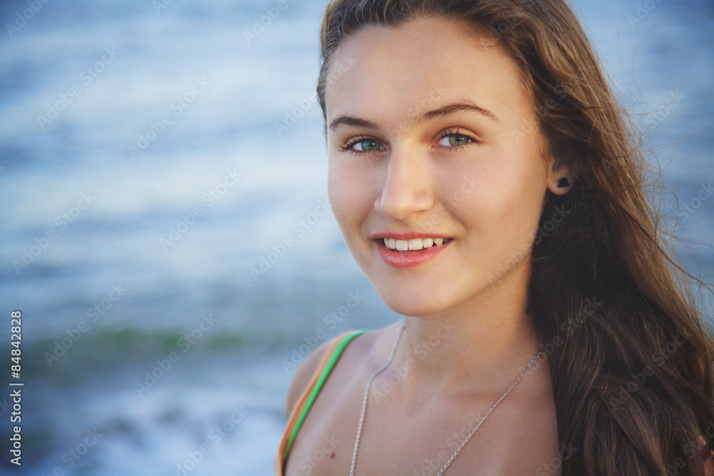 Portrait of young beautiful girl on beach at sunset Portrait of young beautiful girl on beach at sunset
