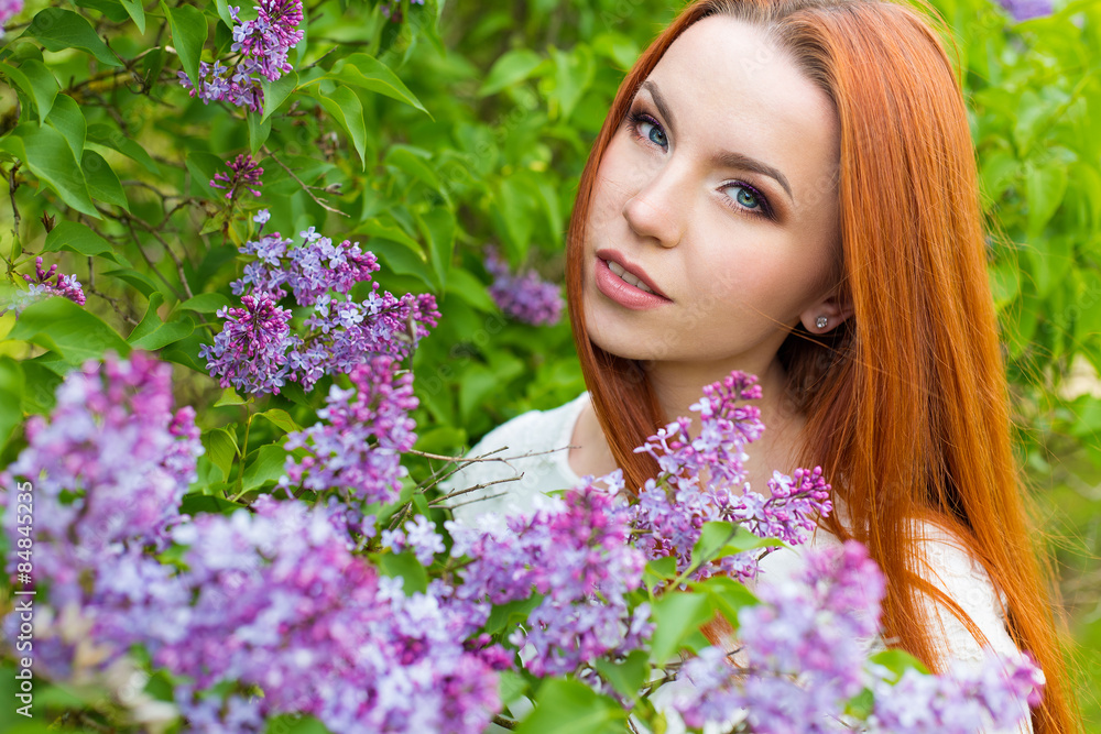 beautiful cute sexy red-haired girl with long hair in a white dress with a bouquet of lilac in the hands of beautiful cute sexy red-haired girl with long hair in a white dress with a bouquet of lilac in the hands of