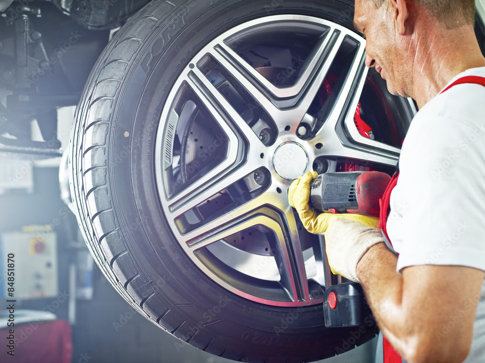 Motor mechanic is changing a tyre Motor mechanic is changing a tyre