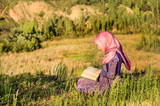 Muslim Woman Reading Holy Quran, outdoors