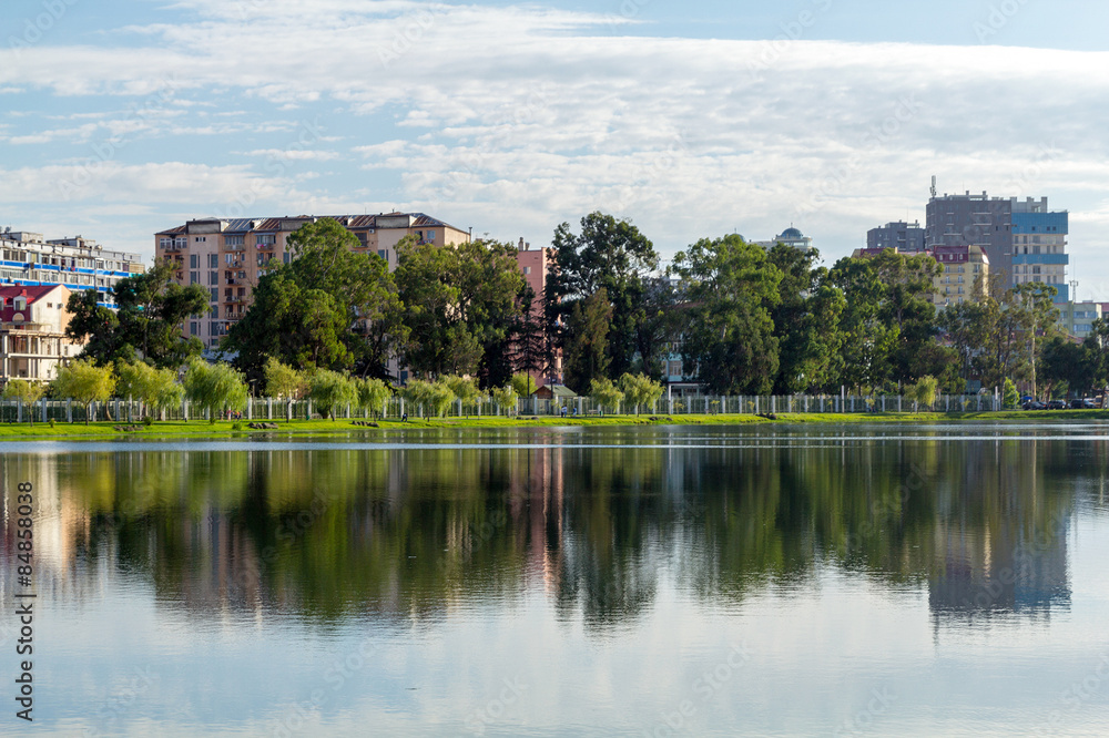 Naklejka premium Houses reflected in the water of Lake Nuri. Batumi. Georgia