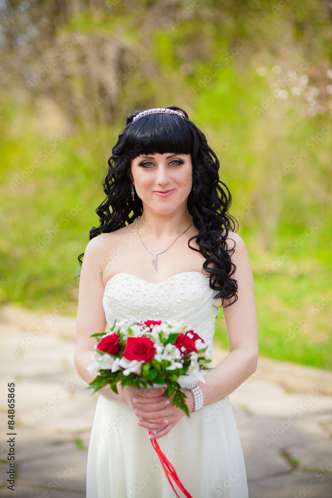 a bridal bouquet of roses in hands of the bride a bridal bouquet of roses in hands of the bride