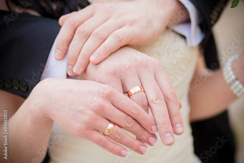 Wedding rings on the hands of the bride and groom