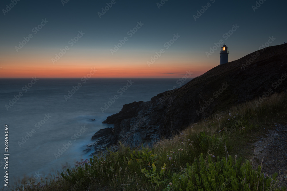 Trevose Head lighthouse on rocky cliffs in Cornwall, England