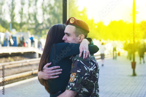 girl meets a soldier at the station in Ukraine