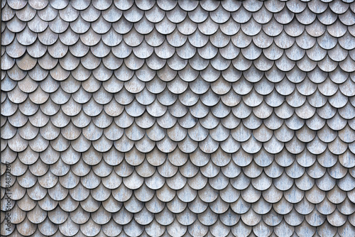 The wall covered with wooden shingles - wooden background horizontal.