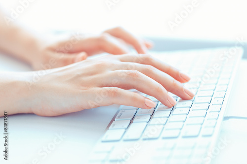 Female woman office worker typing on the keyboard