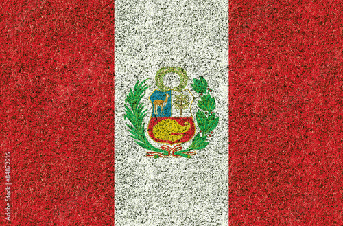 Peru flag texture on green grass in the garden for background