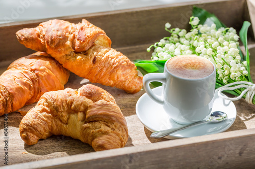 Delicious hot coffee and fresh croissant