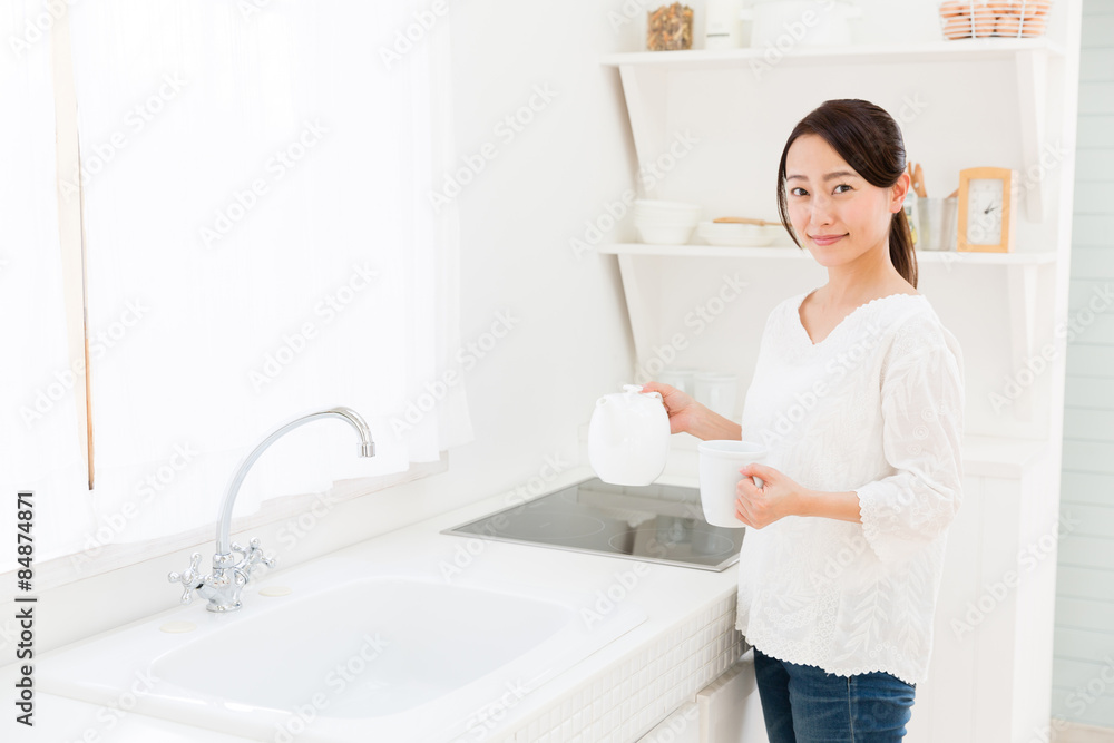 young asian woman in the kitchen young asian woman in the kitchen