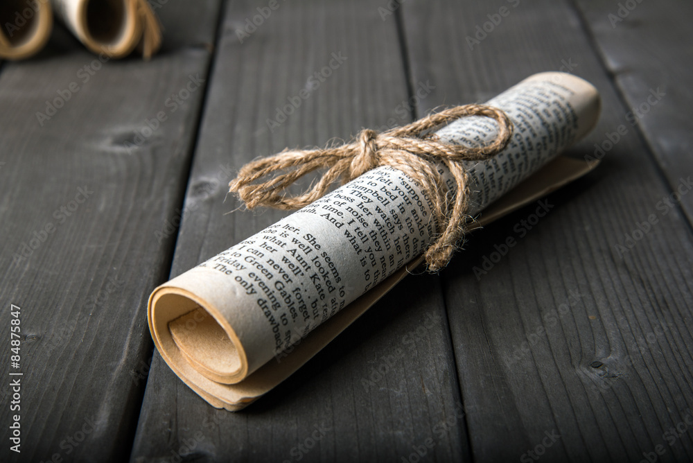 old paper rolls on wooden background old paper rolls on wooden background