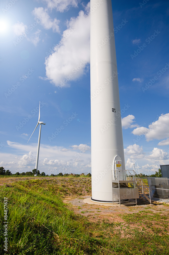 wind turbine against cloudy blue sky background