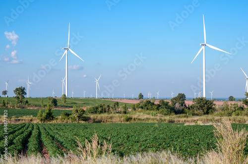 wind turbine against cloudy blue sky background