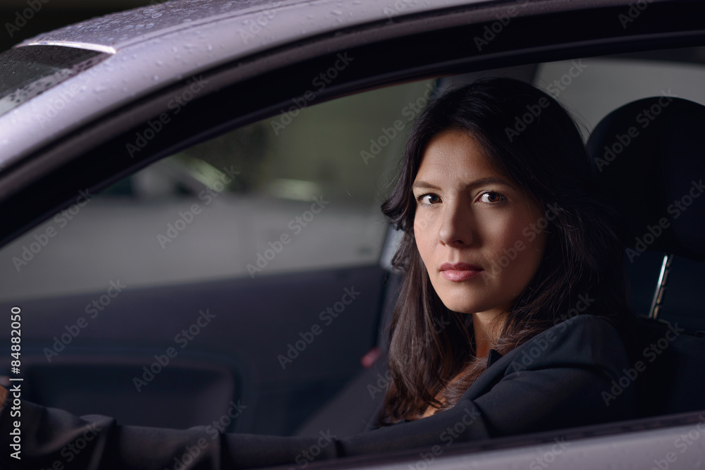 Young woman driving her car at night
