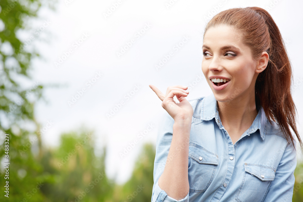 Pretty young woman showing in garden. Beauty smiling girl outsid Pretty young woman showing in garden. Beauty smiling girl outsid