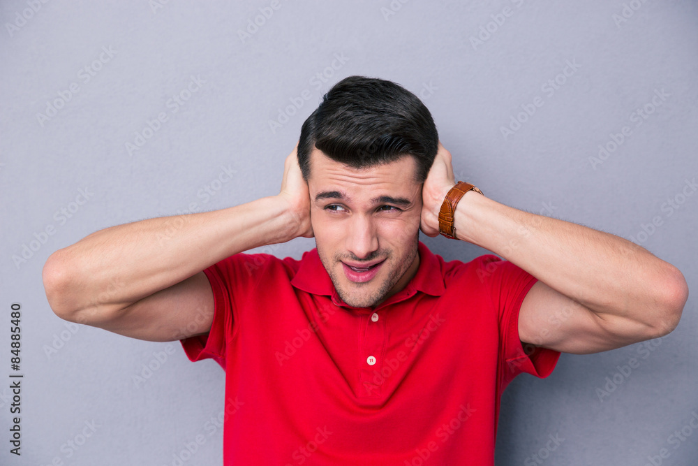 Casual handsome man covering his ears Casual handsome man covering his ears