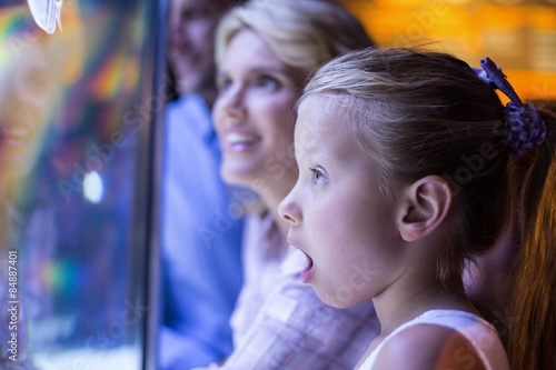 Surprised daughter behind a starfish tank 