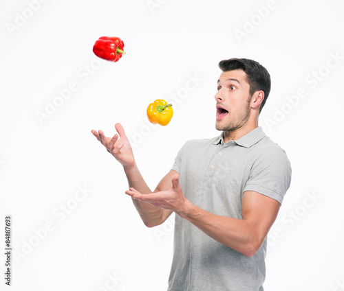 Young man juggling pepper
