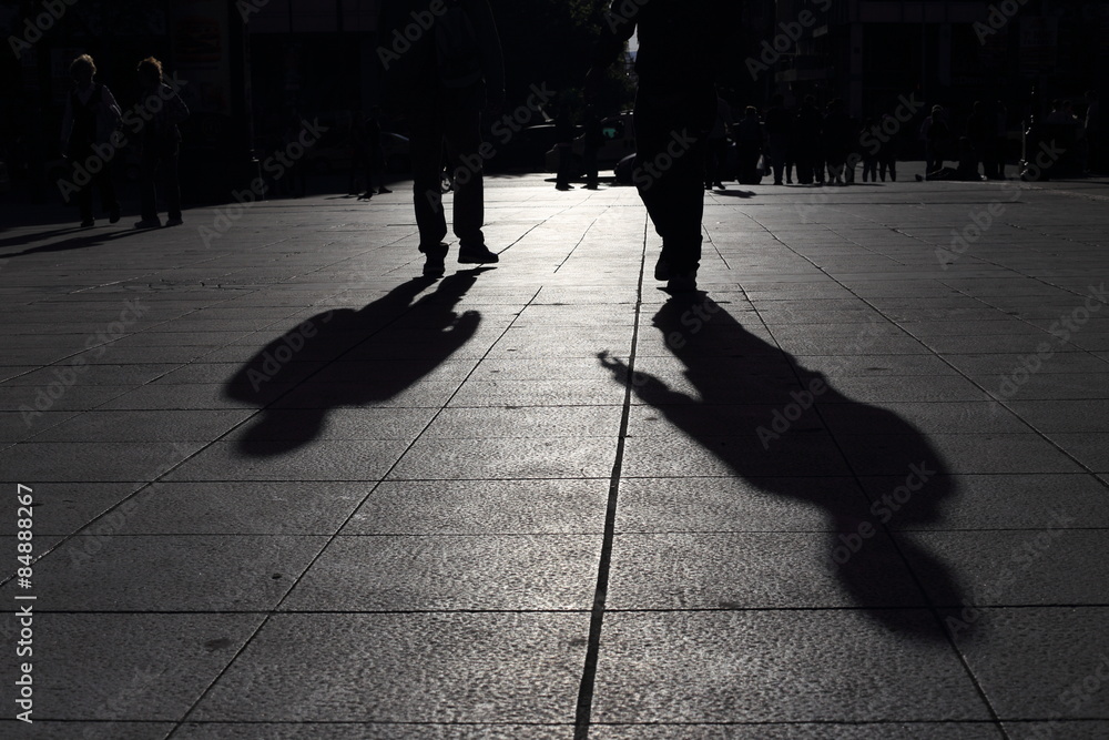 Shadows of people walking in a street of the city, Athens