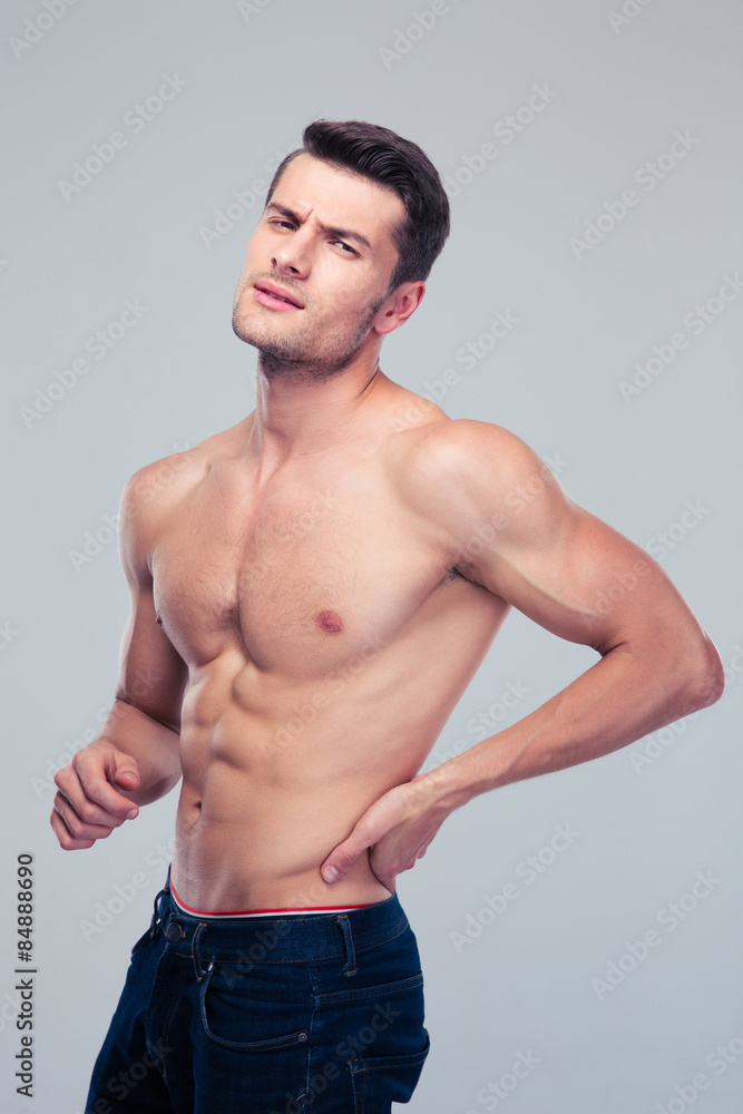 Muscular man having pain in back