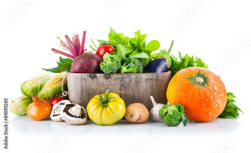 Fresh vegetables in wooden bucket with leaf lettuce. Isolated