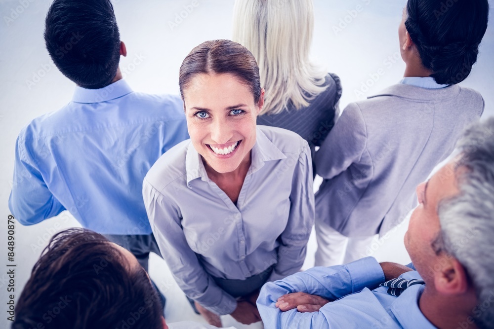 Fototapeta premium Businesswoman looking at camera with her colleague around her 