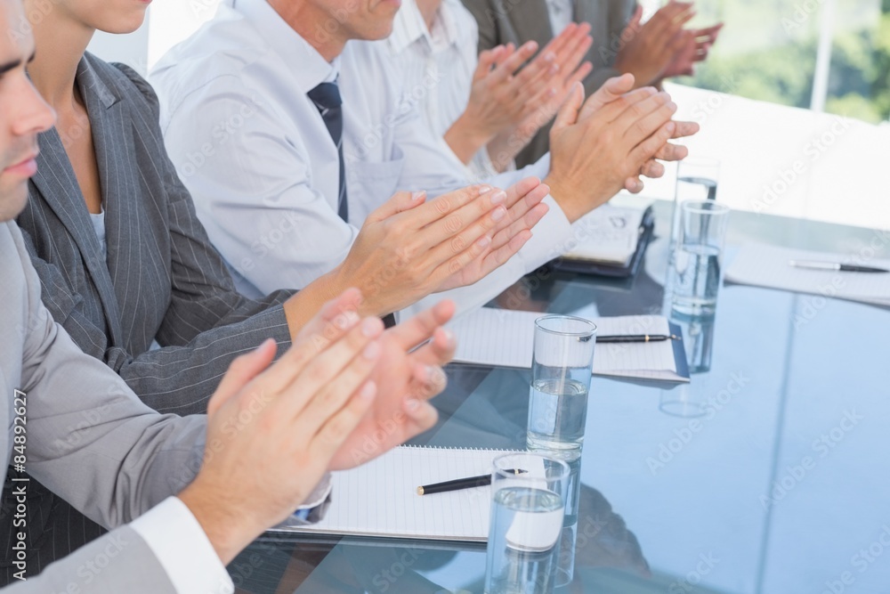 Business team applauding during conference Business team applauding during conference