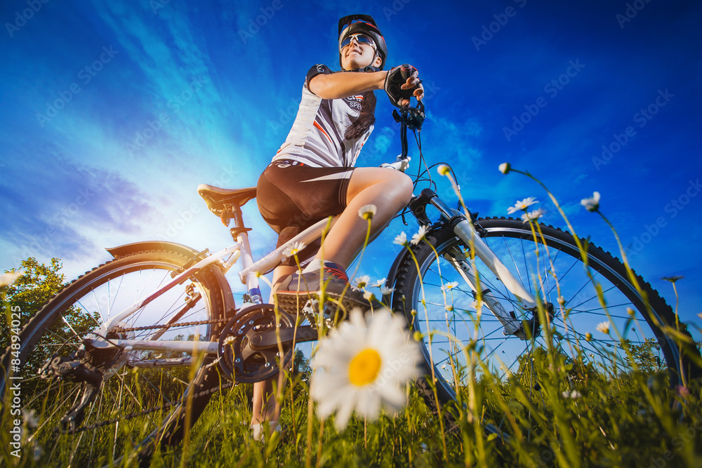 Fototapeta premium Woman is riding bicycle outside