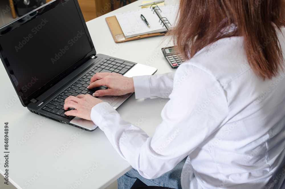 Businesswoman typing on a laptop Businesswoman typing on a laptop
