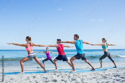 Friends doing yoga together with their teacher 