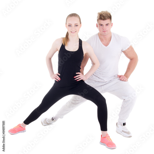 sporty man and woman stretching isolated on white