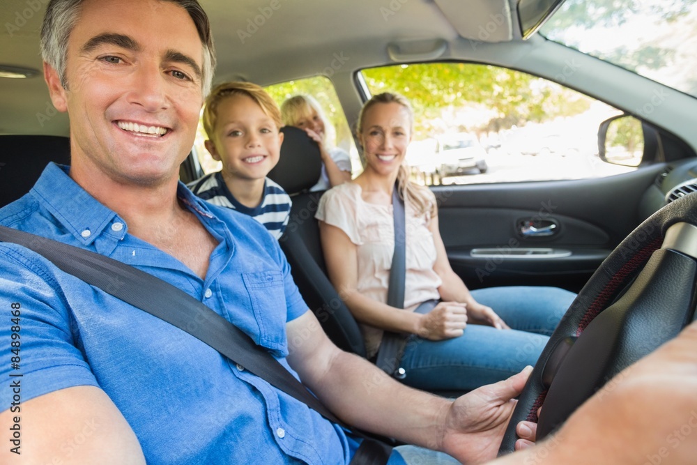 Happy family smiling at the camera in the car Happy family smiling at the camera in the car